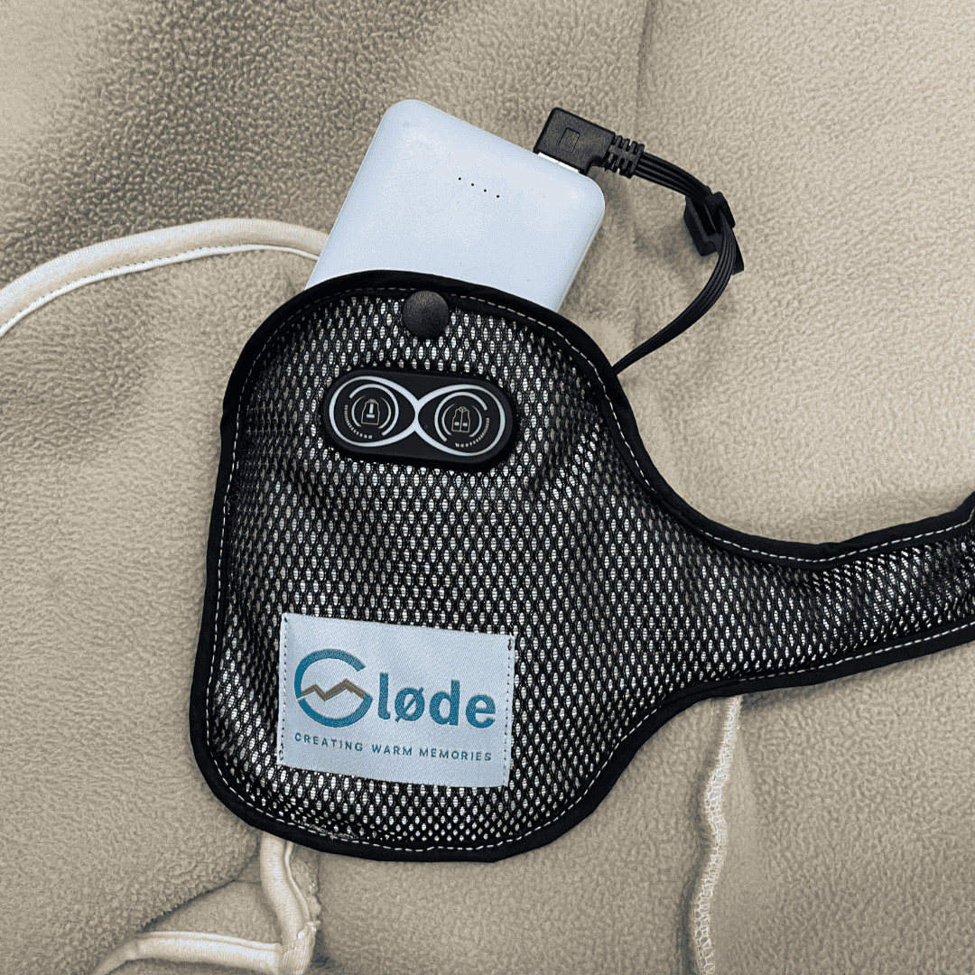Øney warmte-element geklikt aan de binnenkant van een jas, met aansluitkabel naar de powerbank